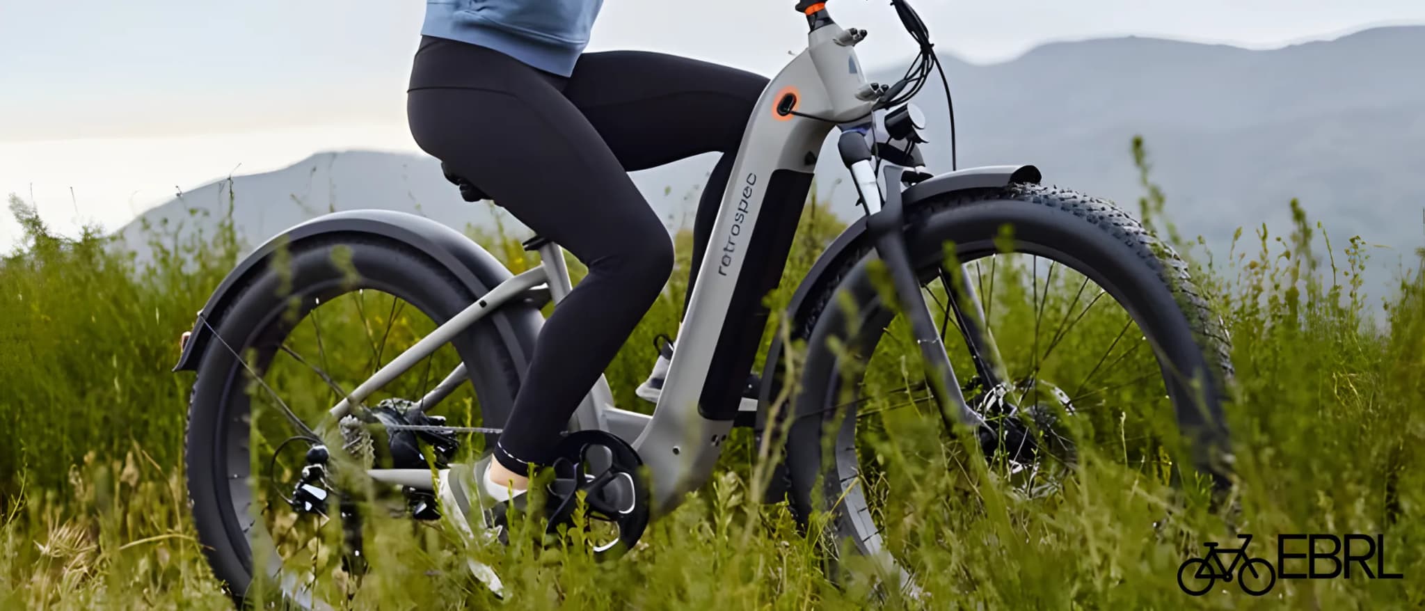 Retrospec Koa Rev 2 Step-Through fat tire electric bike on a mixed gravel and pavement trail