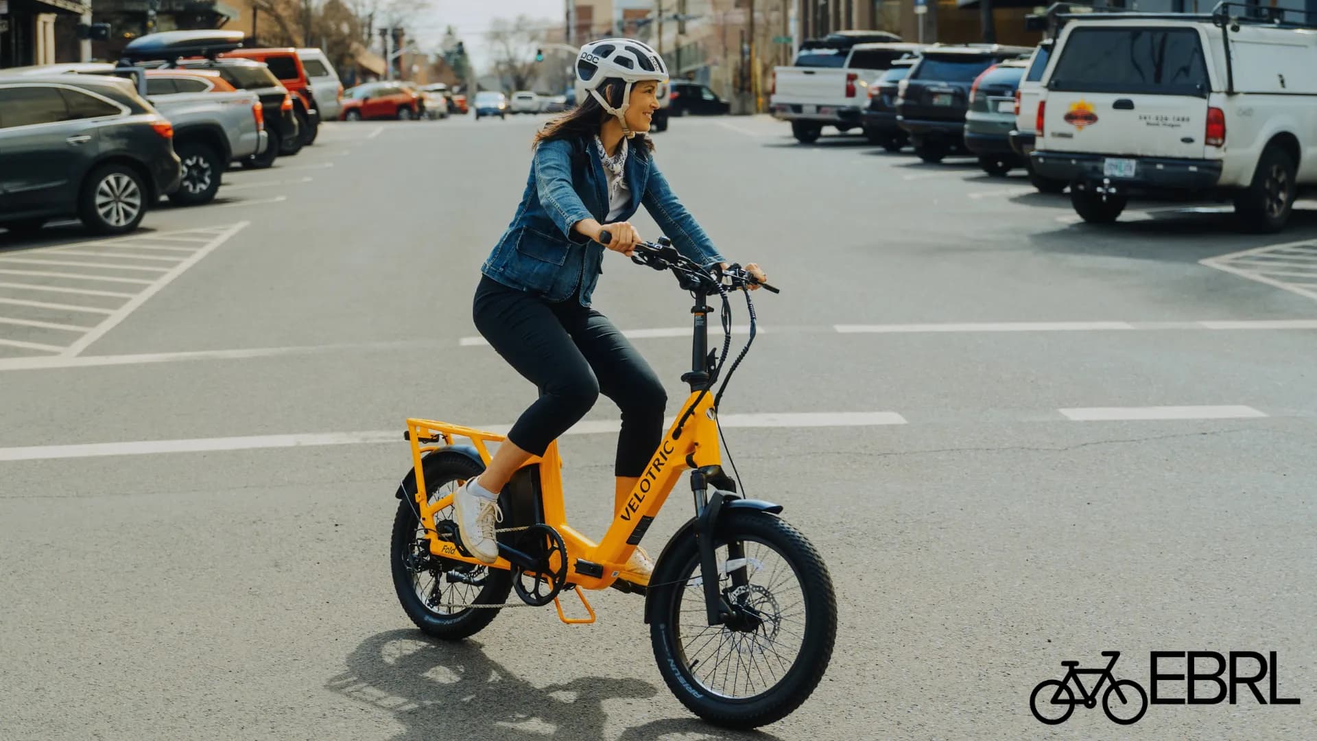 Rider on Velotric Fold 1 Plus folding ebike on urban bike path
