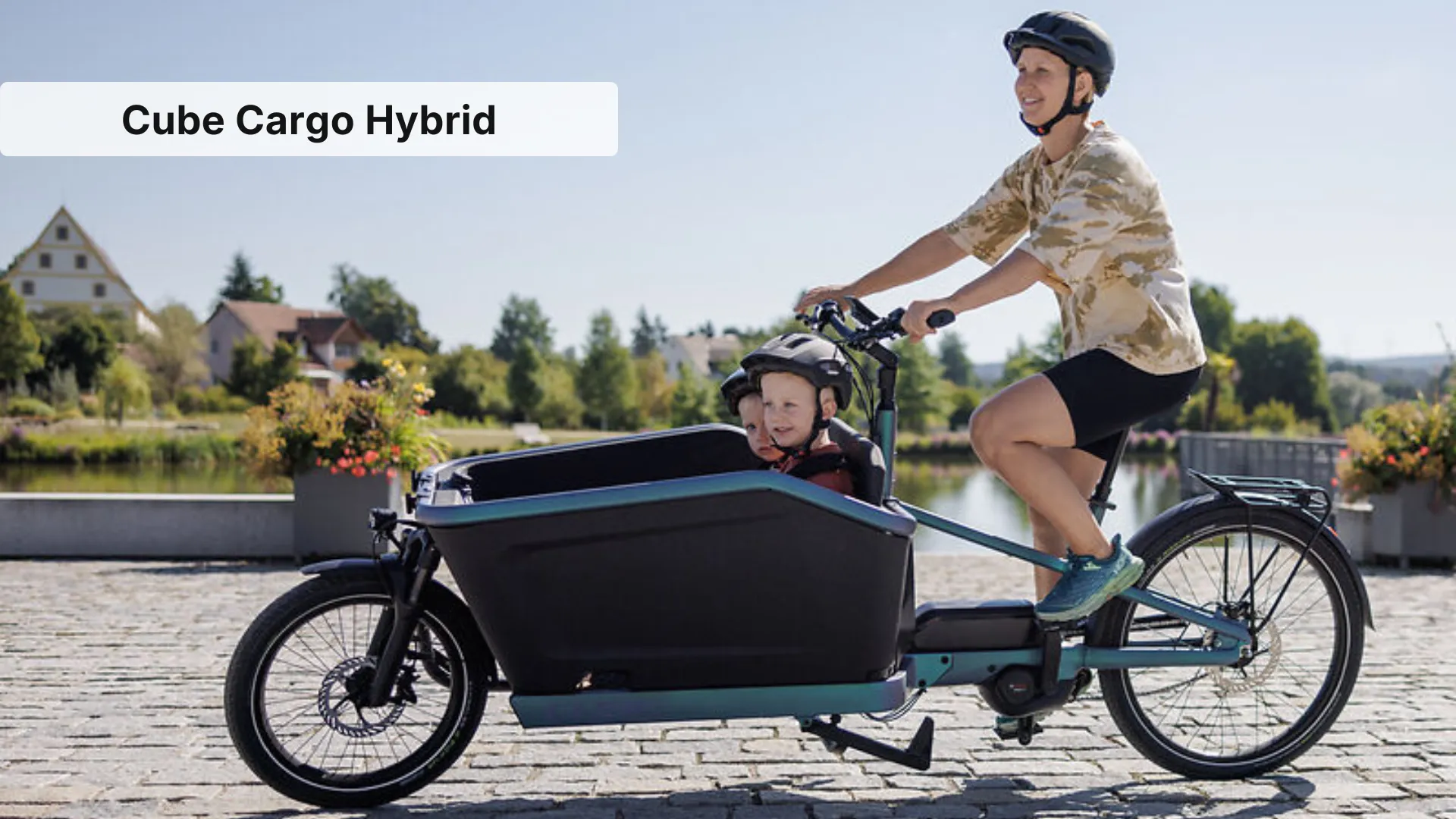 Cube Cargo Hybrid electric cargo bike with front box loaded in urban setting