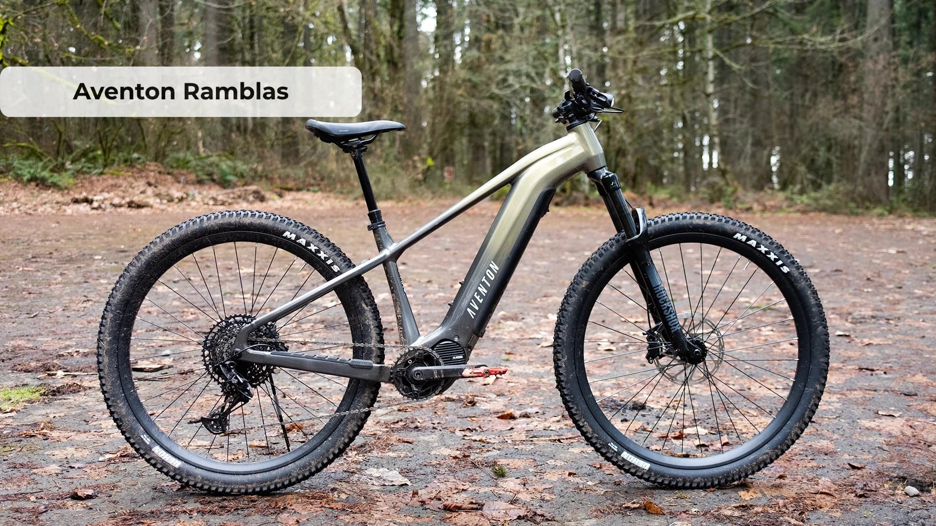Aventon Ramblas electric mountain bike on rugged trail with RockShox suspension and mid-drive motor