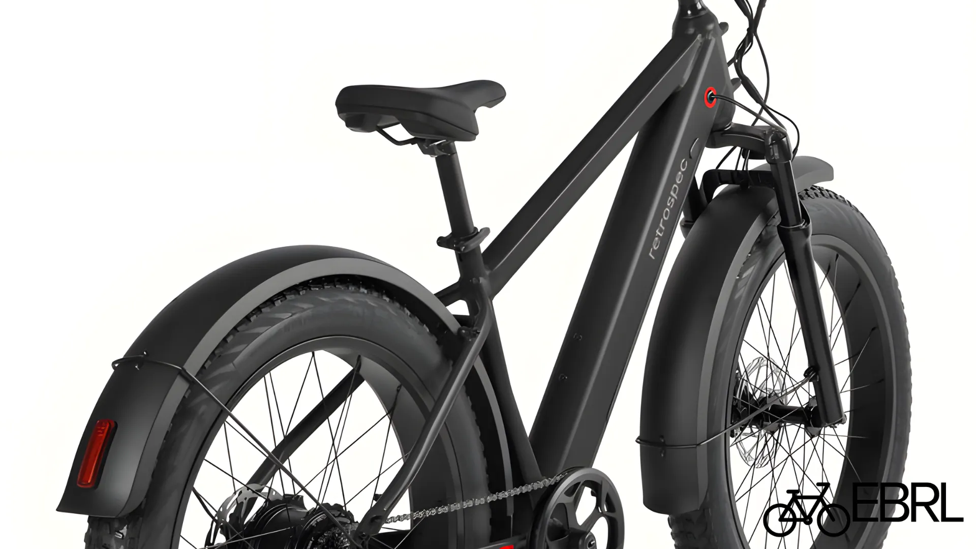 Rider on Retrospec Koa Rev 3 fat tire electric bike on gravel path