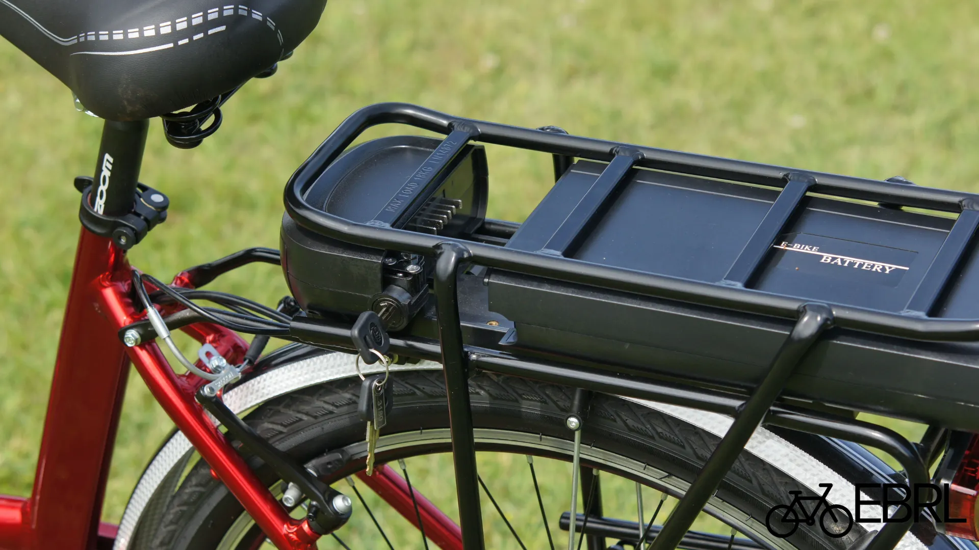 Folded e-bike stored in an apartment corner with airflow, clear of the exit